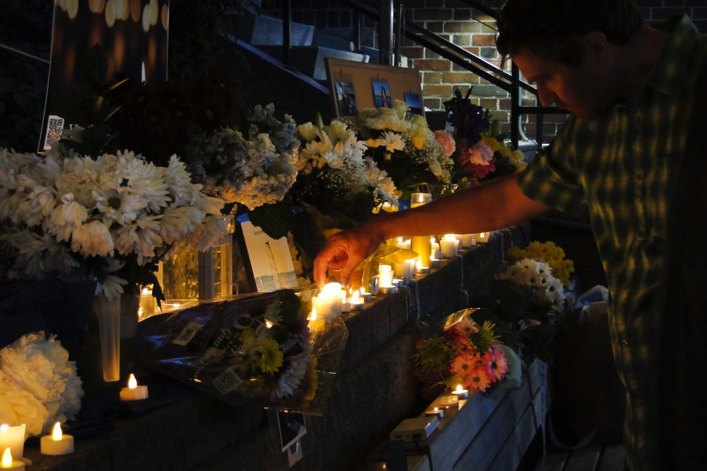 Family, friends and colleagues lit candles and talked about memories they had of Chen as the sun set. 