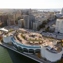 Counter clockwise from lower left, Lake Monona, the Monona Terrace Community and Convention Center, and Wisconsin State Capitol are pictured in an aerial view of the downtown Madison skyline during an autumn sunset on Oct. 5, 2011. In the background, right of center, is the University of Wisconsin-Madison campus, Picnic Point and Lake Mendota. The photograph was made from a helicopter looking west. (Photo by Jeff Miller/UW-Madison)