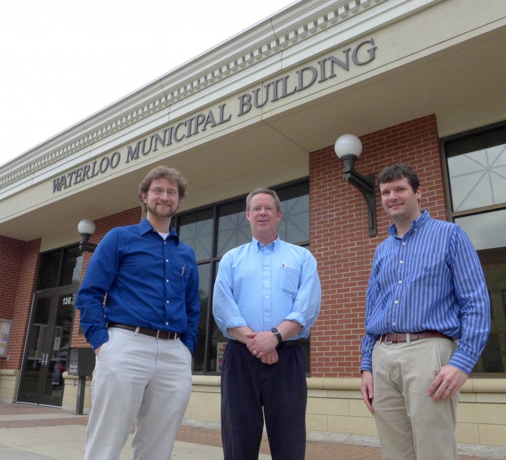 From left, Andrew Lewandowski, a pediatrician who heads the city’s renewable energy committee, city clerk-treasurer Mo Hansen, and Scott Williams, research and education coordinator at the Wisconsin Energy Institute, in front of Waterloo City Hall. 