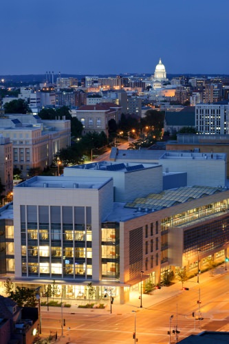 Photo: Discovery Building lit up at night with lit up State Capitol dome on horizon