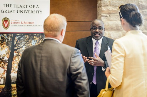 Photo: Duane Cooper talking with 2 unidentified people