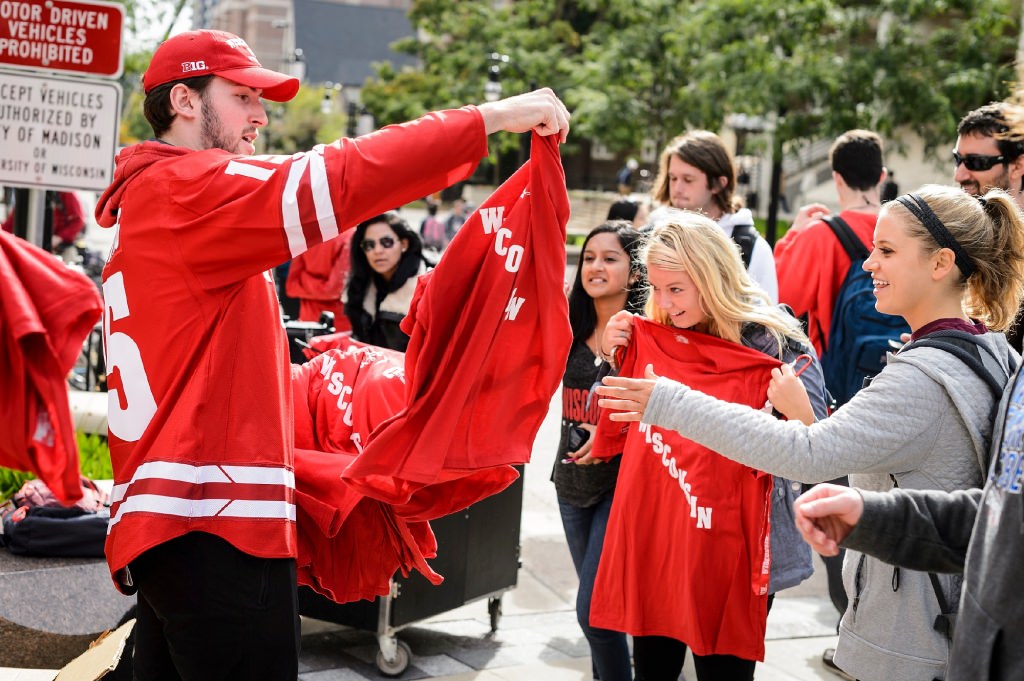 Photo: Hockey player handing out shirt