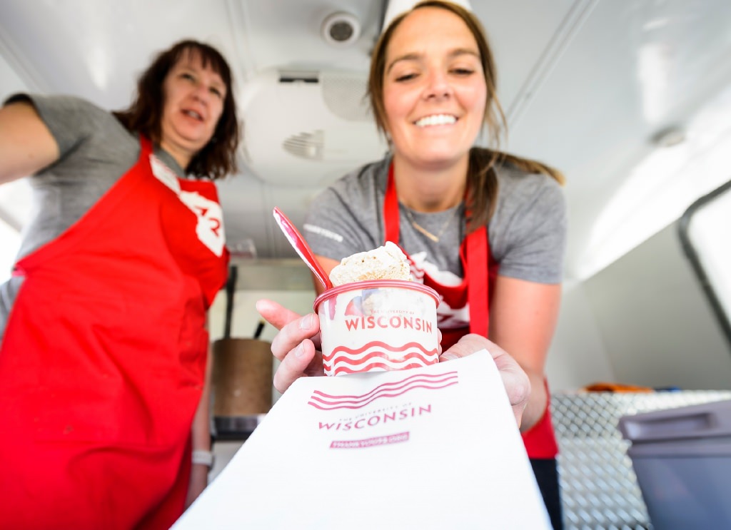 WFAA marketing coordinator Julia Kinsey serves scoops of ice cream from the 