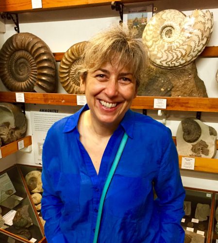 Photo: Pupa Gilbert standing in front of display of seashells