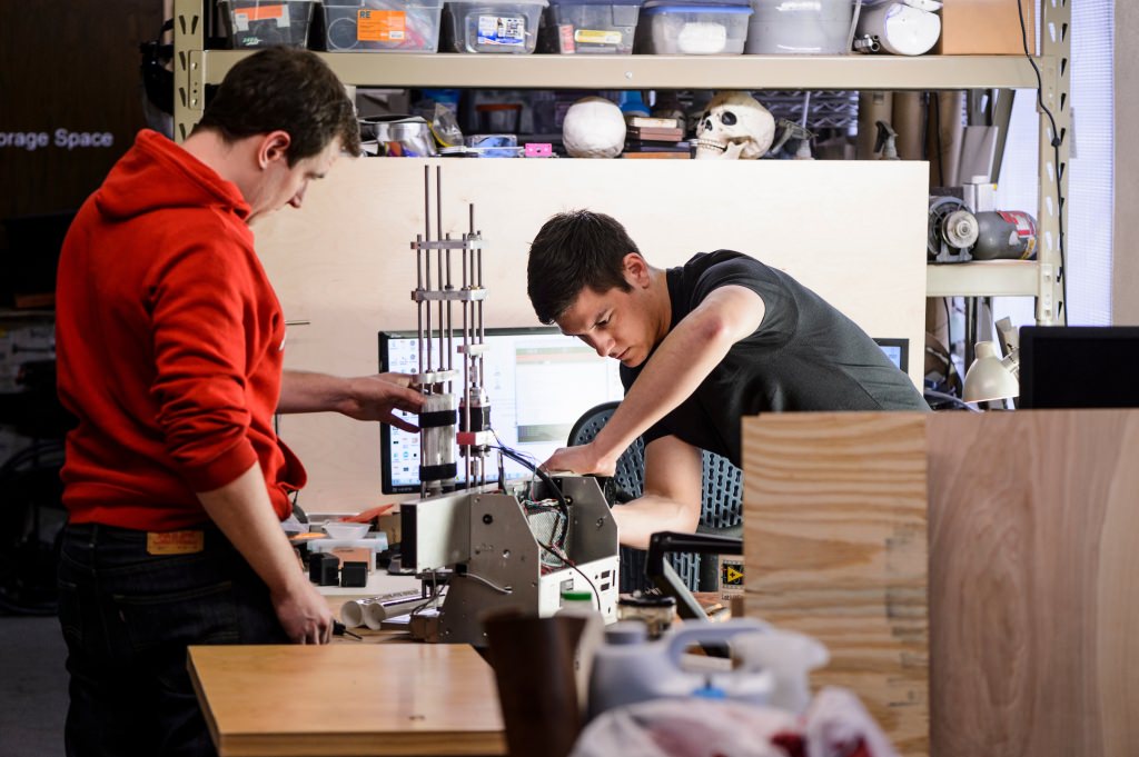 Photo: Re Mixer founders Brian Pekron and Eric Ronning adjusting an automated testing device