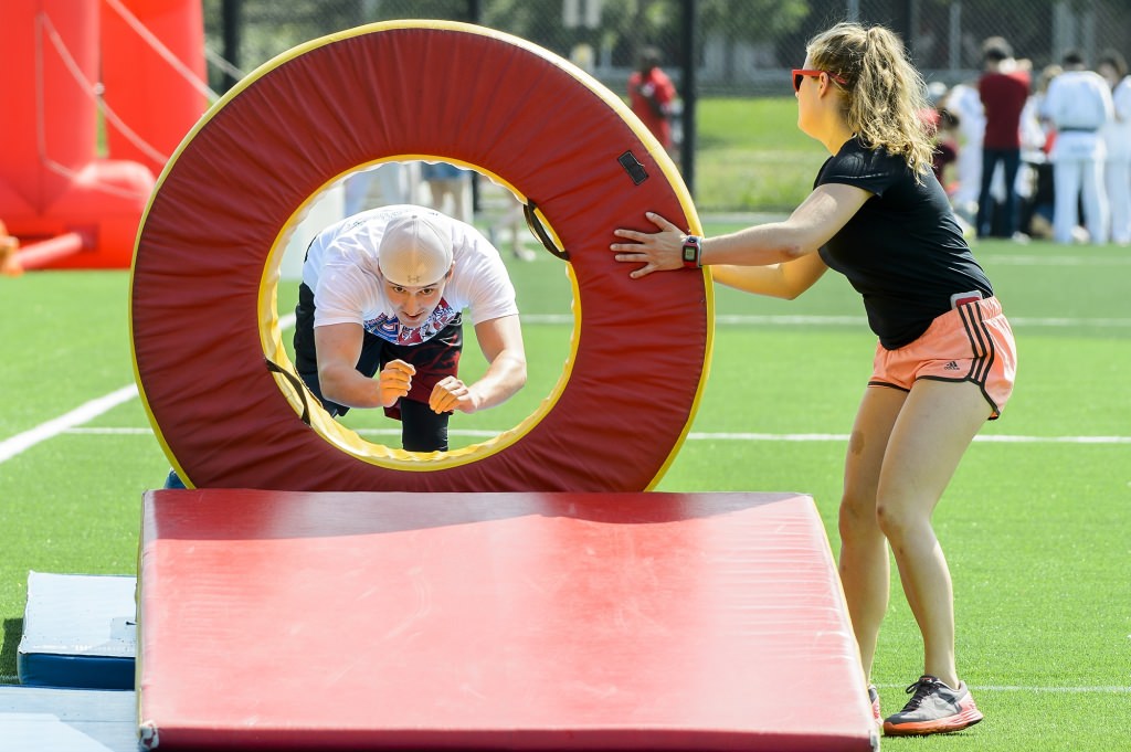 Photo: Zach Thomas diving through a ring in an obstacle course