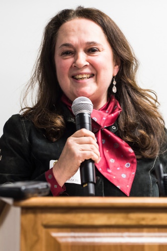 Photo: Emily Auerbach speaking at podium