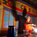 Photo: Bassam Shakhashiri presenting science show in dark room illuminated from lab bench