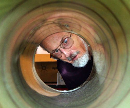 Photo: Charles Bentley peeking through the barrel of an ice drill