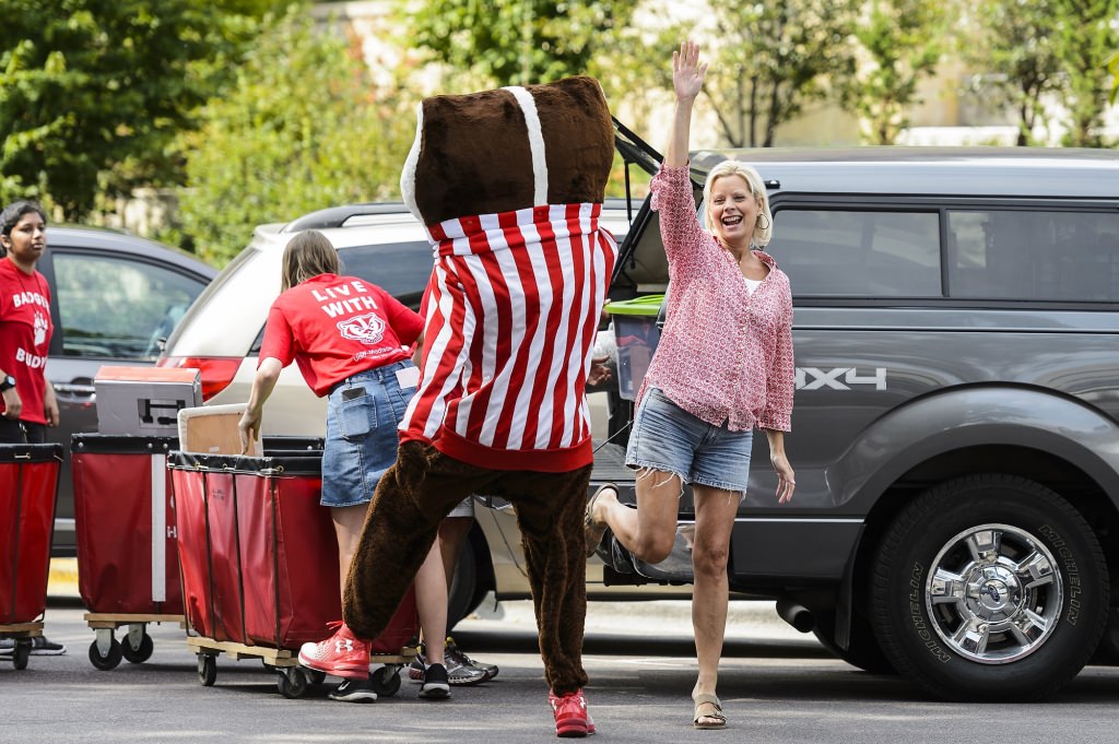 Photo: Becky Frielich high-fives Bucky