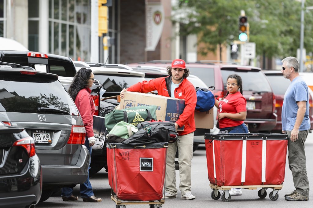 Countless Badger Buddy volunteers welcome and help new students -- including, at center, undergraduate James Fischer of Columbus, Ohio -- moving into Witte Residence Hall at the University of Wisconsin-Madison on Aug. 26, 2017. Move in continues on Aug, 29, 30 and 31, and leads into weeks of Wisconsin Welcome programming and the start of the fall semester. (Photo by Jeff Miller / UW-Madison)