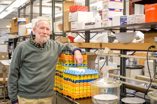 Photo: Mark Cook leaning on stack of egg cartons