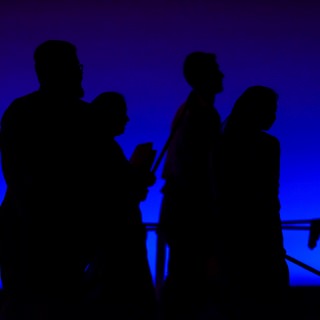 Silhouetted student members of the UW School of Bhangra walk off stage after performing at the Multicultural Orientation and Reception (MCOR) at the Wisconsin Union Theater's Shannon Hall.