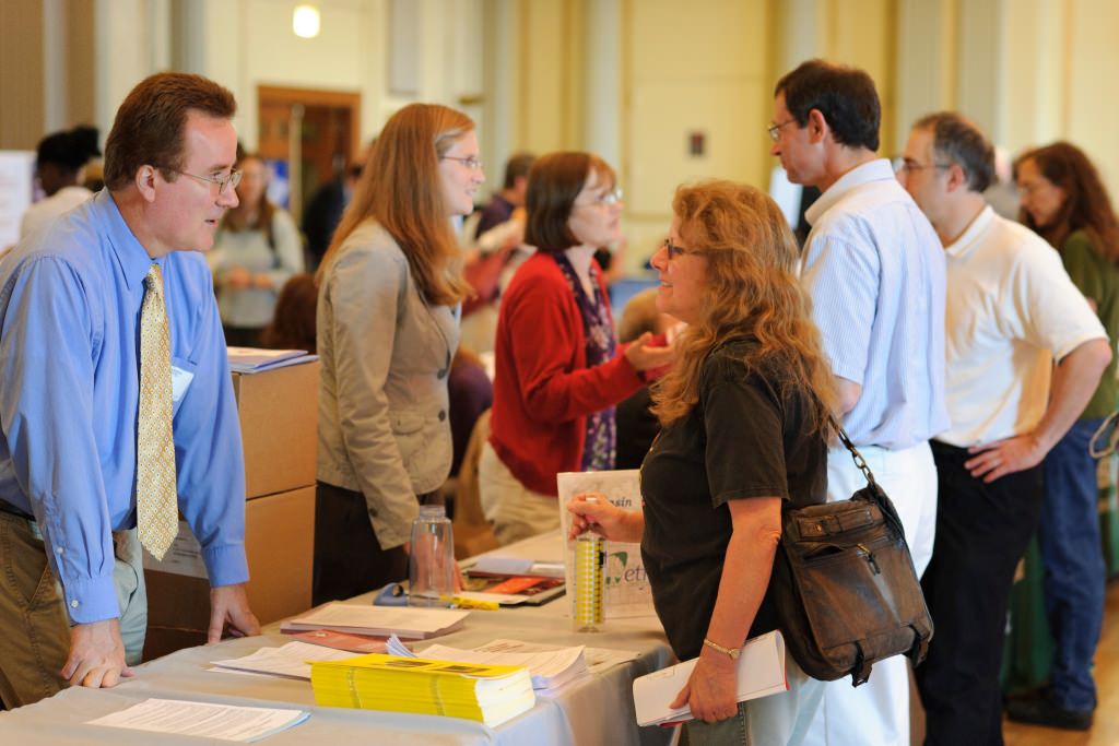 Photo: Employees talking with benefits representatives