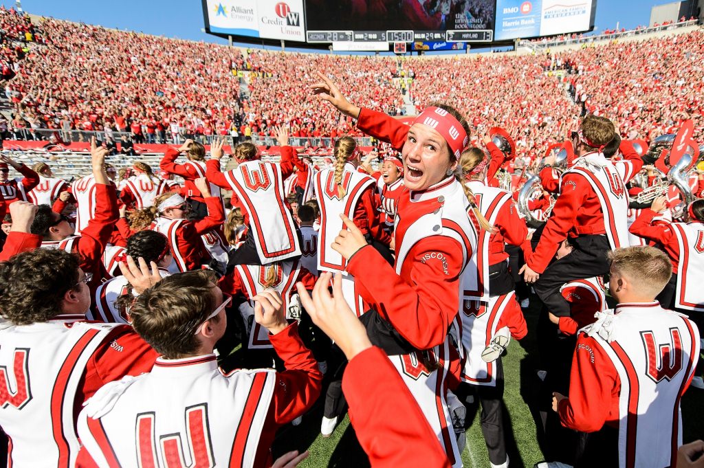 Photo: Uniformed band members dance in Camp Randall Stadium.