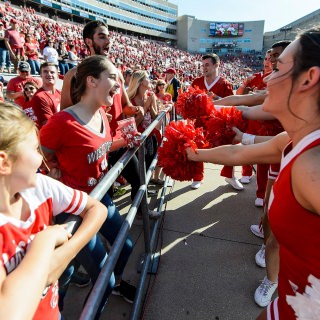 Members of the UW Spirit Squad engage with fans during the fifth quarter celebration following the UW Homecoming football games versus Maryland inside Camp Randall Stadium at the University of Wisconsin-Madison on Oct. 21, 2017. The Badgers won the game 38-13. (Photo by Bryce Richter / UW-Madison)