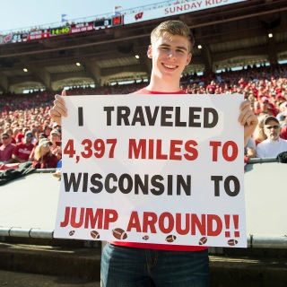 Martin Janku, a Badger and Jump Around fan from the Czech Republic, holds up a sign describing his commitment during the UW Homecoming football games versus Maryland inside Camp Randall Stadium at the University of Wisconsin-Madison on Oct. 21, 2017. The Badgers won the game 38-13. (Photo by Bryce Richter / UW-Madison)