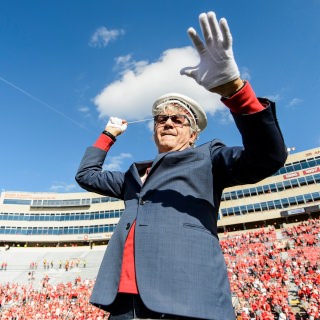 UW-Madison alum Steve Miller, of the Steve Miller Band, conducts the UW Marching Band during the fifth quarter celebration follow the UW Homecoming football games versus Maryland inside Camp Randall Stadium at the University of Wisconsin-Madison on Oct. 21, 2017. The Badgers won the game 38-13. (Photo by Bryce Richter / UW-Madison)