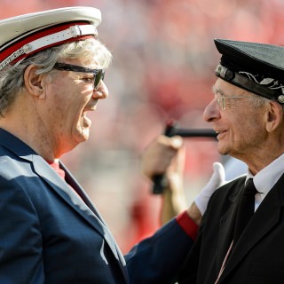 UW-Madison alum Steve Miller, of the Steve Miller Band, talks with UW Band director Michael Leckrone during the fifth quarter celebration follow the UW Homecoming football games versus Maryland inside Camp Randall Stadium at the University of Wisconsin-Madison on Oct. 21, 2017. The Badgers won the game 38-13. (Photo by Bryce Richter / UW-Madison)