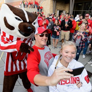 Badger fans pose with UW mascot Bucky Badger for a selfie during the Badger Bash at Union South before the UW Homecoming football games versus Maryland inside Camp Randall Stadium at the University of Wisconsin-Madison on Oct. 21, 2017. The Badgers won the game 38-13. (Photo by Bryce Richter / UW-Madison)