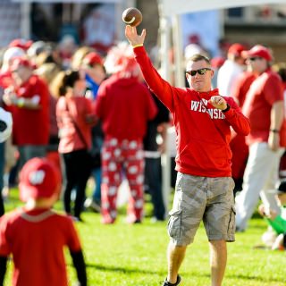 David Putz and his son Drennan toss a football around during the Badgerville pregame event prior to the UW Homecoming football games versus Maryland inside Camp Randall Stadium at the University of Wisconsin-Madison on Oct. 21, 2017. The Badgers won the game 38-13. (Photo by Bryce Richter / UW-Madison)