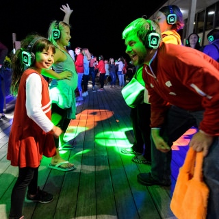 UW alum Chris Harrison and daughter Sophia dance the night away at the silent disco event during the UW Homecoming Block Party at Alumni Park at the University of Wisconsin-Madison on Oct. 20, 2017. The event followed the Homecoming Parade that took place earlier in the evening. (Photo by Bryce Richter / UW-Madison)