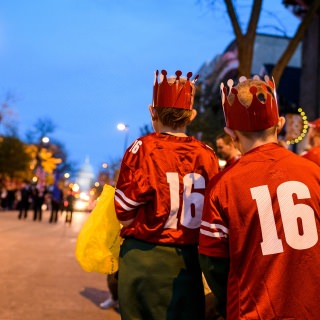 Children anxiously await the potential for receiving candy as spirited students dance and parade floats travel down State Street during the University of Wisconsin-Madison's Homecoming Parade on Oct. 20, 2017. The annual parade is one of many Homecoming week activities sponsored by the Wisconsin Alumni Association (WAA). (Photo by Jeff Miller / UW-Madison)