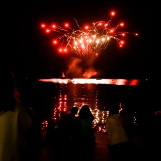 UW-Madison alumni, students and members of the Madison community line Goodspeed Family Pier to take in a firework display over Lake Mendota during the UW Homecoming Block Party at Alumni Park at the University of Wisconsin-Madison on Oct. 20, 2017. The event followed the Homecoming Parade that took place earlier in the evening. (Photo by Jeff Miller / UW-Madison)