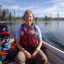 Photo: Monica Turner in life jacket sitting in a boat on an unidentified lake