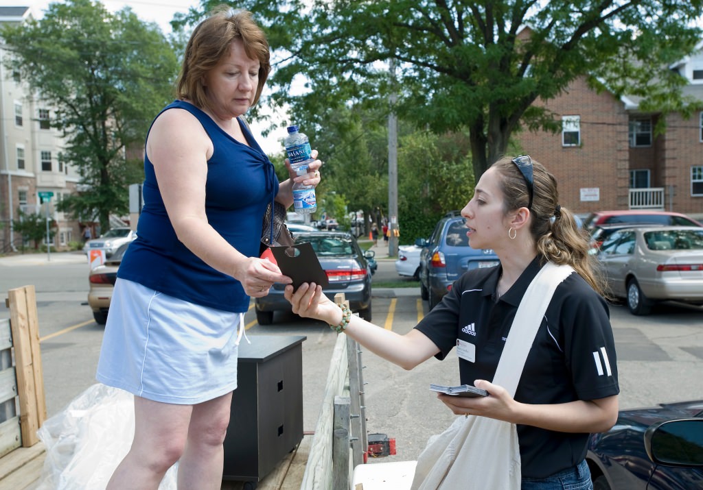 Photo: Nancy Hoffman handing information to parent