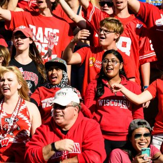 Badger fans sing to the UW Marching Band's performance of the song, "hey, Baby," during "Fifth Quarter" of a UW Homecoming football game played at Camp Randall Stadium at the University of Wisconsin-Madison on Oct. 21, 2017. The Wisconsin Badgers beat the Maryland Terrapins, 38-13. (Photo by Jeff Miller / UW-Madison)