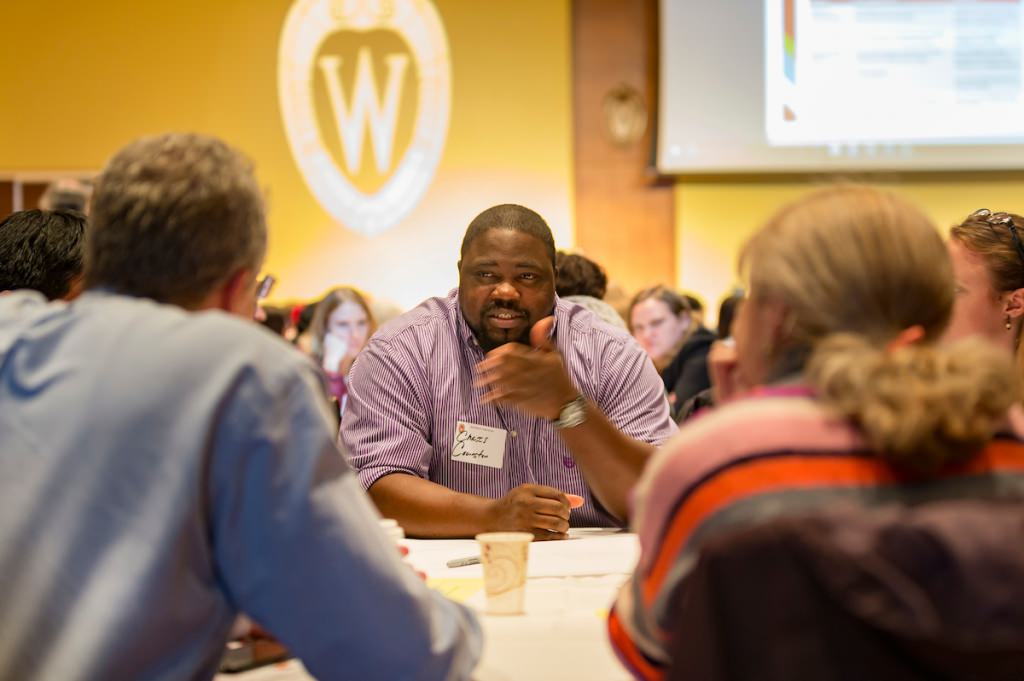 Photo: Participants sitting at table and discussing diversity