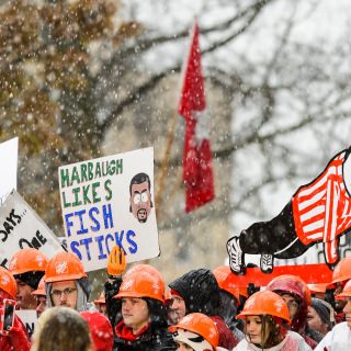 Photo of fans holding signs.