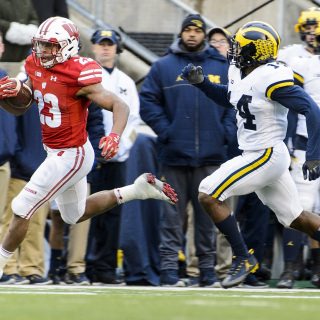 Photo of running back Jonathan Taylor (23) rushing with the ball.