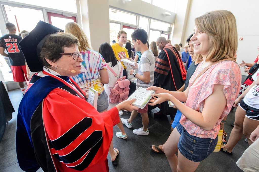 Photo: Rebecca Blank handing book to student