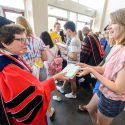 Photo: Rebecca Blank handing book to student