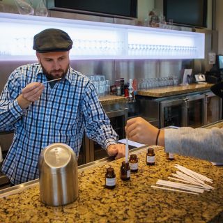 A cheese Maker and affineur, Bill Anderson, left, sniffs a sample of aromas that finds in cheese making during a Family Weekend's the Life of Cheese: A Tasting and Science of Cheese event at Discovery Building's Steenbock's on Orchard Restaurant in Madison, WI. Saturday, Nov. 4, 2017. This event was about an exploration and tasting of cheese as it ages, from cheese curds to Parmesan-Reggiano. Anderson brought three types of cheese that he makes. (Photo by Hyunsoo Léo Kim | University Communications)