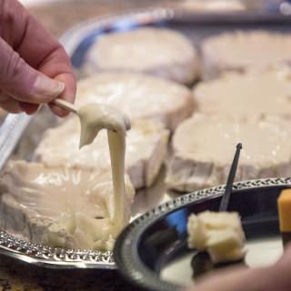 Brenda Cornelio, takes a sample of Leopold Cheese, a relative of Bree Cheese that produced by Crème de la Coulée at Discovery Building's Steenbock's on Orchard Restaurant in Madison, WI. Saturday, Nov. 4, 2017. This event was about an exploration and tasting of cheese as it ages, from cheese curds to Parmesan-Reggiano. This event is put on by the Wisconsin Science Festival and Steenbock’s on Orchard exclusively for Family Weekend, and it was sold-out. (Photo by Hyunsoo Léo Kim | University Communications)