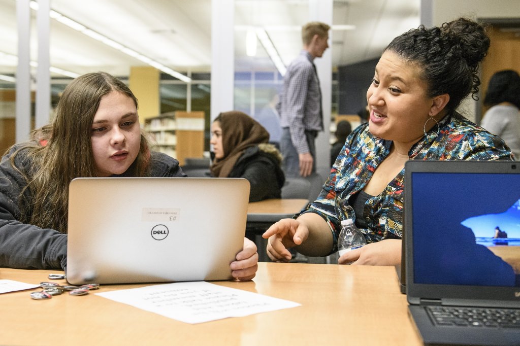 Joselyn Diaz-Valdes (right), senior advisor in the Office of Student Financial Aid at the University of Wisconsin-Madison, talks with prospective student Arianna Perez (left) during a UW community event designed to inform prospective college students about admissions and financial assistance. The event was held at the Goodman Branch of the Madison Public Library on Nov. 13, 2017. (Photo by Bryce Richter / UW-Madison)