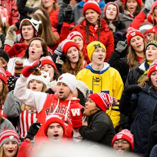 Two Michigan fans join the fun as Wisconsin Badger fans sing to the UW Marching Band's fifth quarter performance of "Hey, Baby," following Wisconsin's 24-10 football victory over the Michigan Wolverines at Camp Randall Stadium at the University of Wisconsin-Madison on Nov. 18, 2017. (Photo by Jeff Miller / UW-Madison)