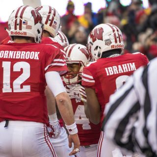 Photo of teammates celebrating wide receiver A.J. Taylor's touchdown catch.