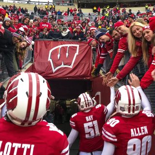 Photo of fans celebrating as the team exits the field.