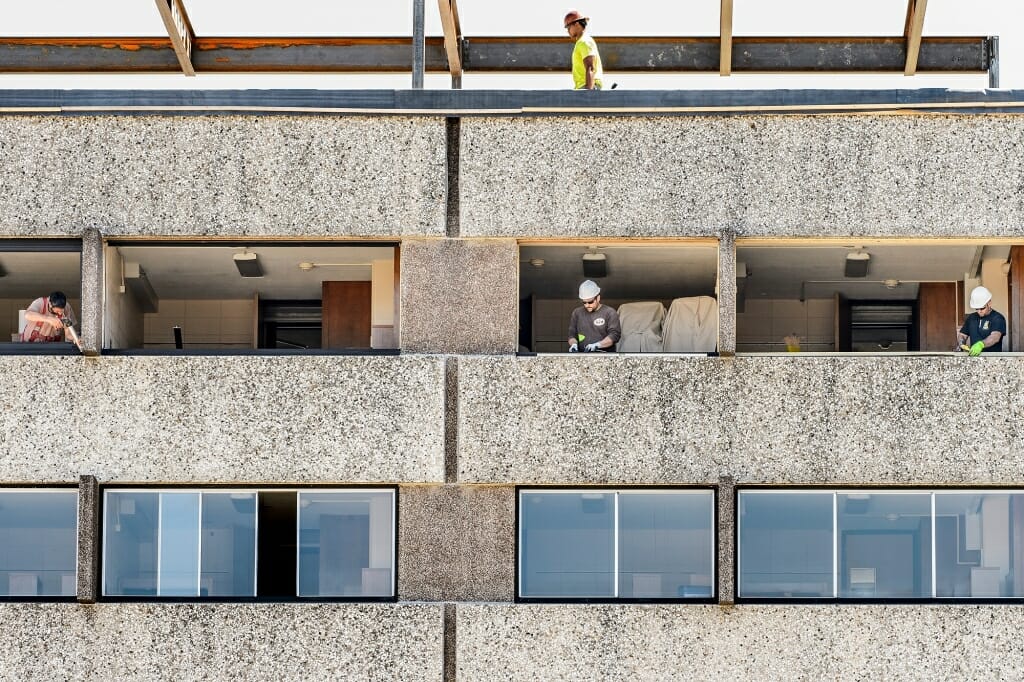 Photo: Workers standing in windows of Witte Residence Hall