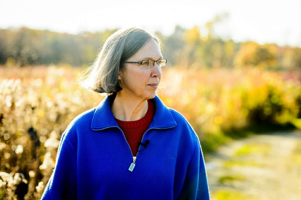 Photo: Karen Oberhauser walking along trail