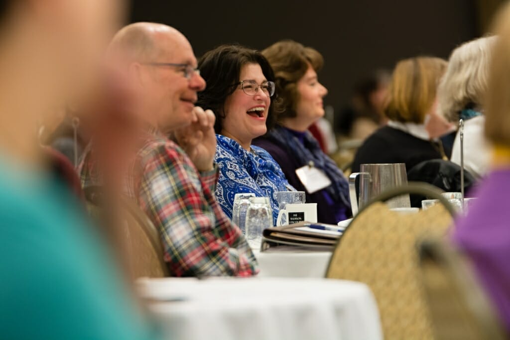 Photo: People sitting in crowd laughing