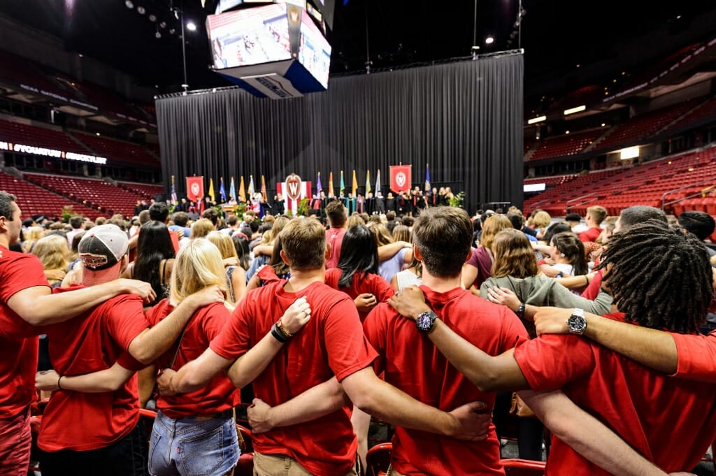 Photo: Large crowd of students with arms locked together behind them