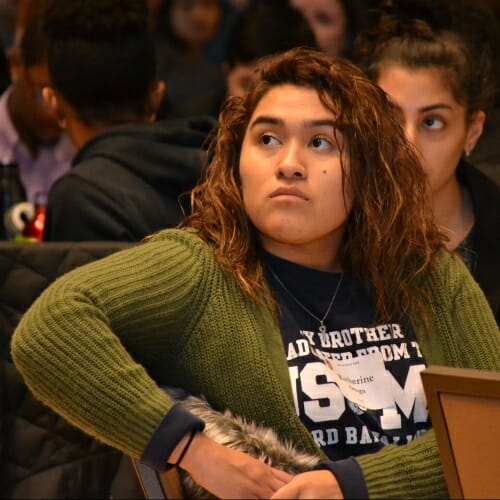 Photo: Seated students listening to speaker