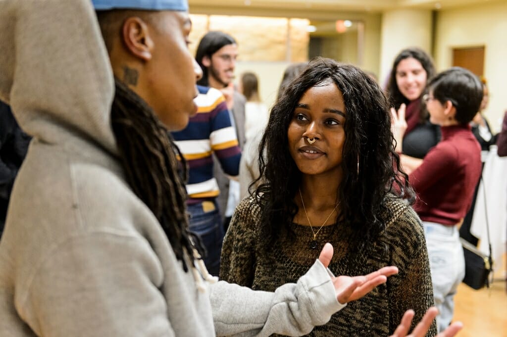 Undergraduate Janetta Hill, with the First Wave program, talks with Waithe.