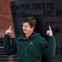 UW alumni Anders Holm points to his plaque and quote at Alumni Park, which reads 