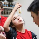 Christine Chang checks the mixture of wheat grain and water during a DNA extraction exercise as part of Bucky's Classroom.